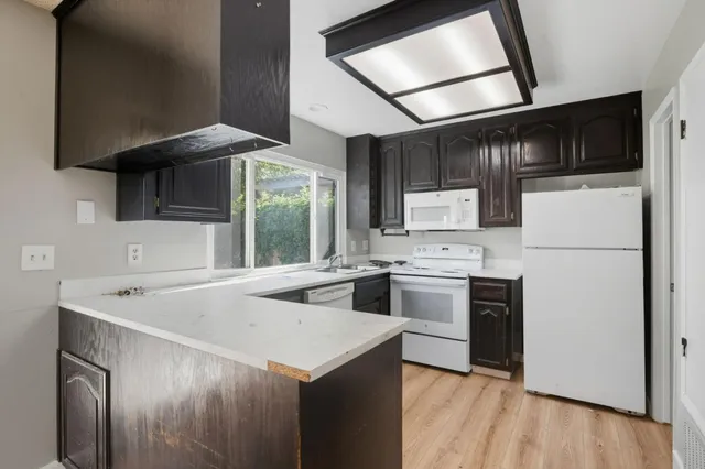a kitchen with a sink stove and refrigerator