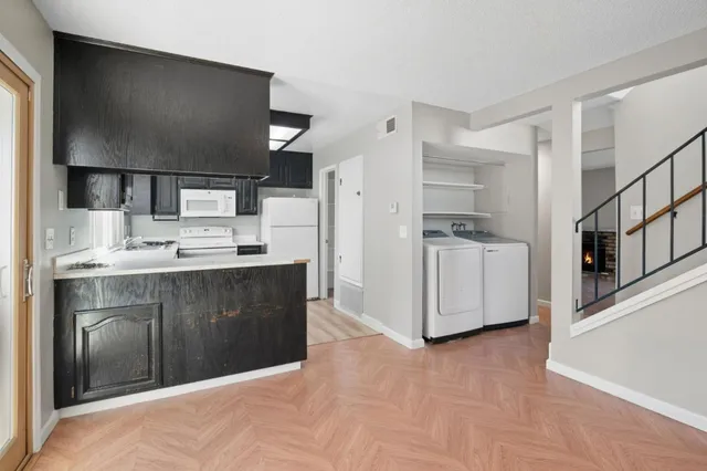 a kitchen with stainless steel appliances a refrigerator and a stove top oven