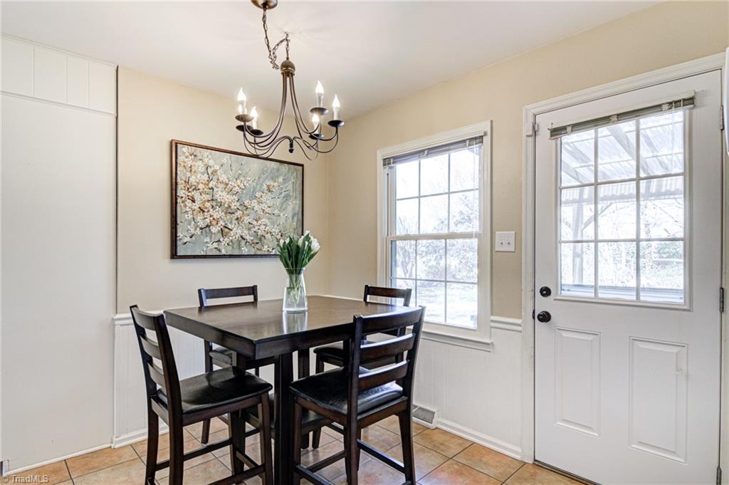 4516 Tower Road Greensboro, NC 27410 - Photo 11 of 26 Casual dining area opens to covered deck/back entry and backyard