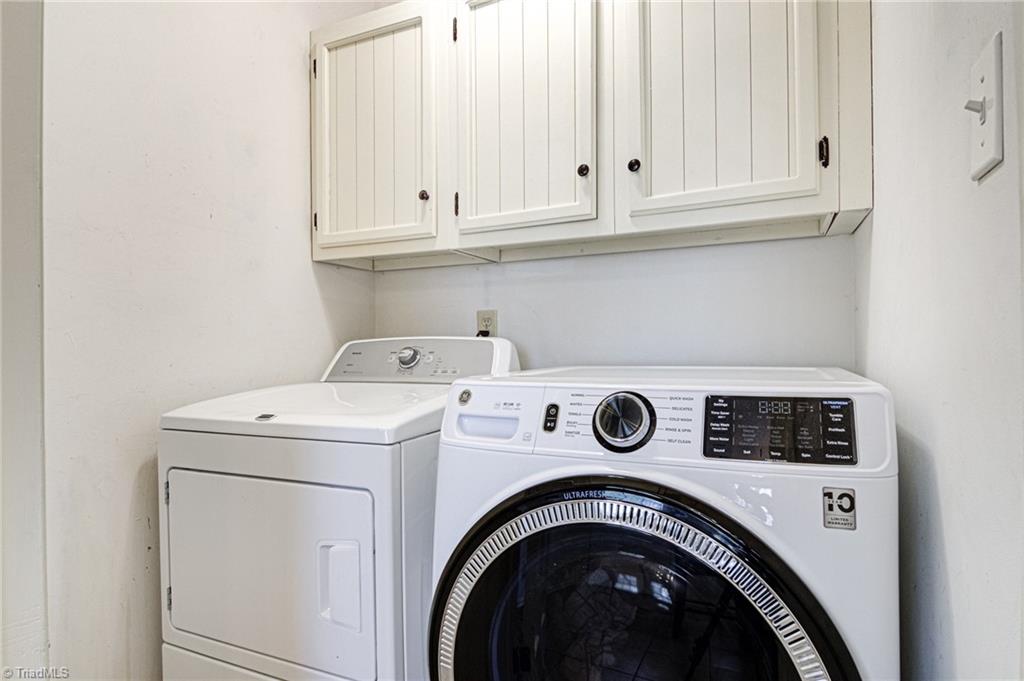 4516 Tower Road Greensboro, NC 27410 - Photo 12 of 26 Laundry area with overflow storage/panty space is neatly tucked away behind a closed door