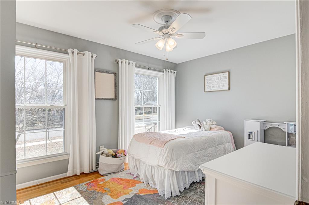4516 Tower Road Greensboro, NC 27410 - Photo 19 of 26 Bedroom 2 overlooks front yard and has original hardwood floors plus ceiling fan