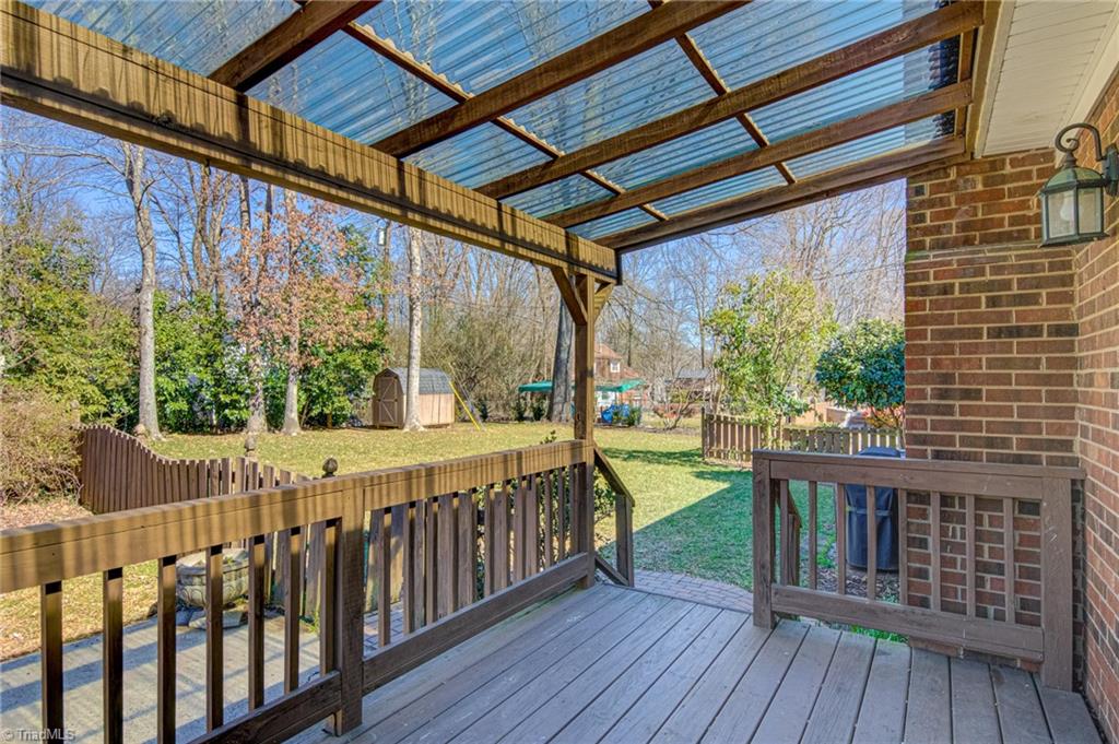 4516 Tower Road Greensboro, NC 27410 - Photo 22 of 26 Covered deck overlooks fully-fenced backyard