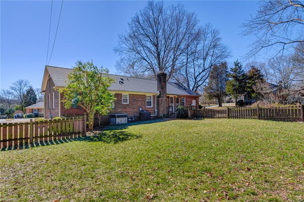 4516 Tower Road Greensboro, NC 27410 - Photo 24 of 26 Enjoy the perks of a fully-fenced, flat, grassy backyard