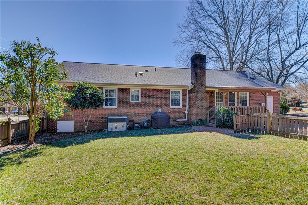 4516 Tower Road Greensboro, NC 27410 - Photo 25 of 26 Tidy backyard with covered deck and direct access to driveway on side of house