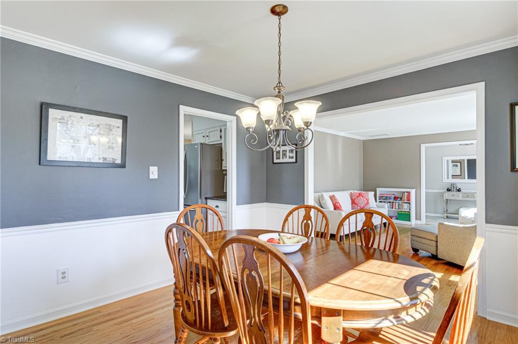 4516 Tower Road Greensboro, NC 27410 - Photo 6 of 26 Traditional Dining Room with hardwoods, chair rail and neutral paint