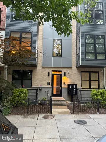 a building with potted plants in front of it