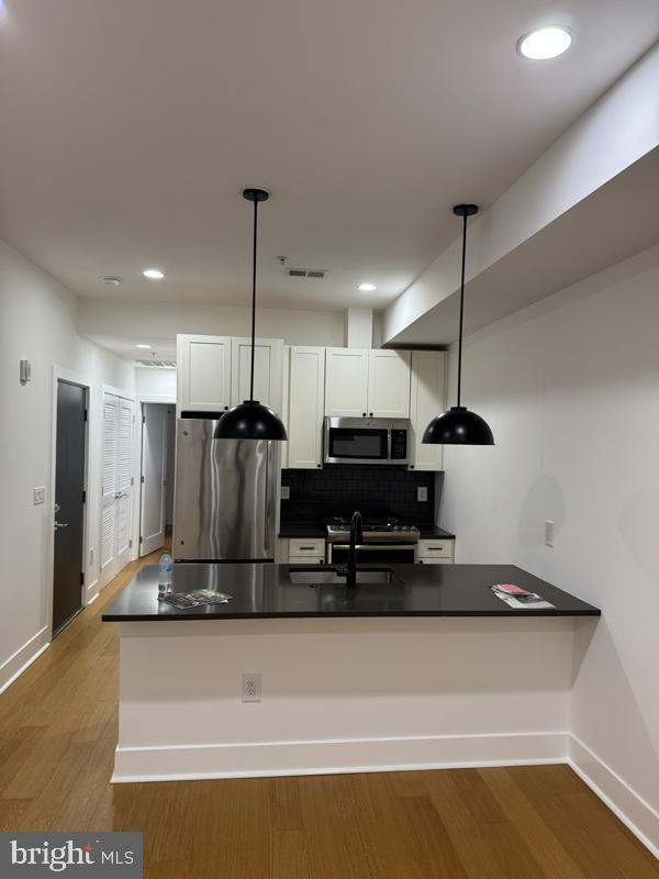 11 15th Street Northeast, Unit 3 Washington, DC 20002 - Photo 2 of 13 a kitchen with kitchen island stainless steel appliances a refrigerator and a counter top