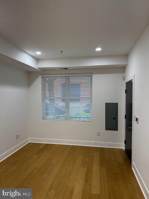 11 15th Street Northeast, Unit 3 Washington, DC 20002 - Photo 6 of 13 a view of an empty room with wooden floor and a window