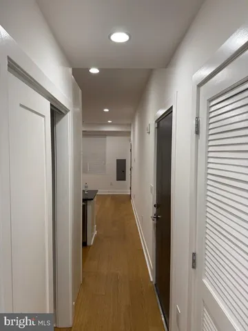 a view of a hallway with wooden shelves
