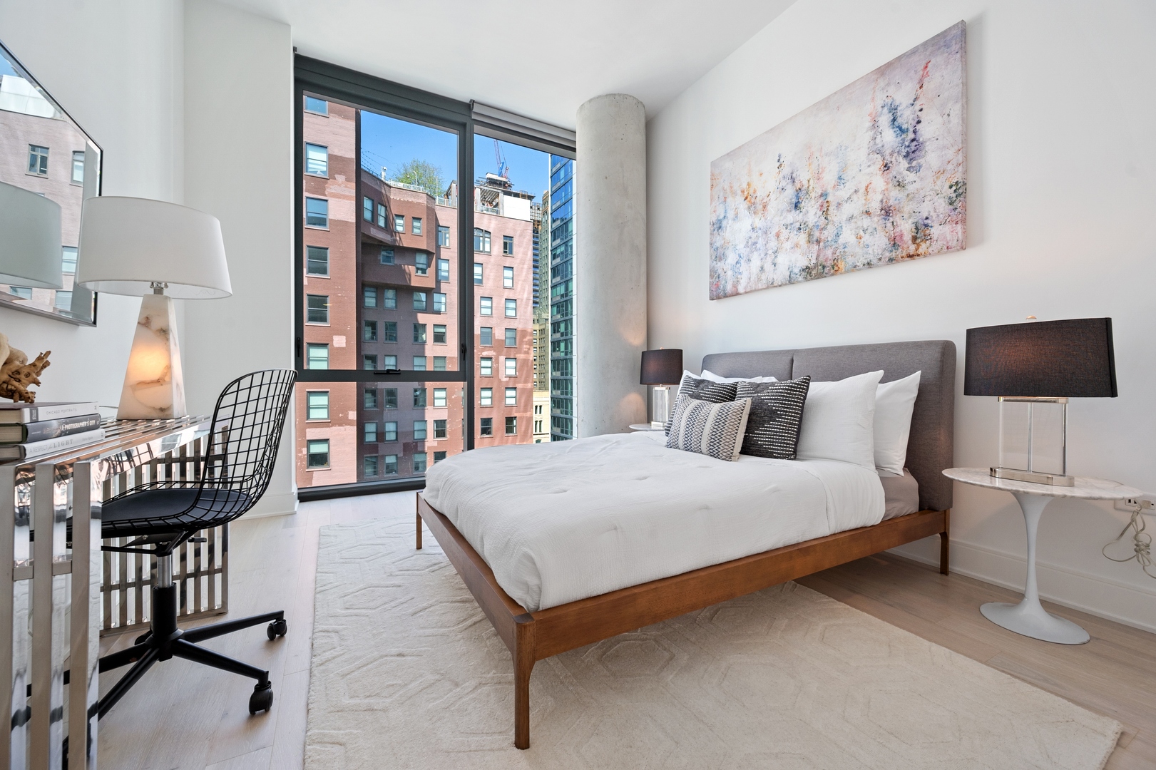 60 East Randolph Street, Unit 20D Chicago, IL 60601 - Photo 12 of 24 a bedroom with a bed a bookshelf and a window