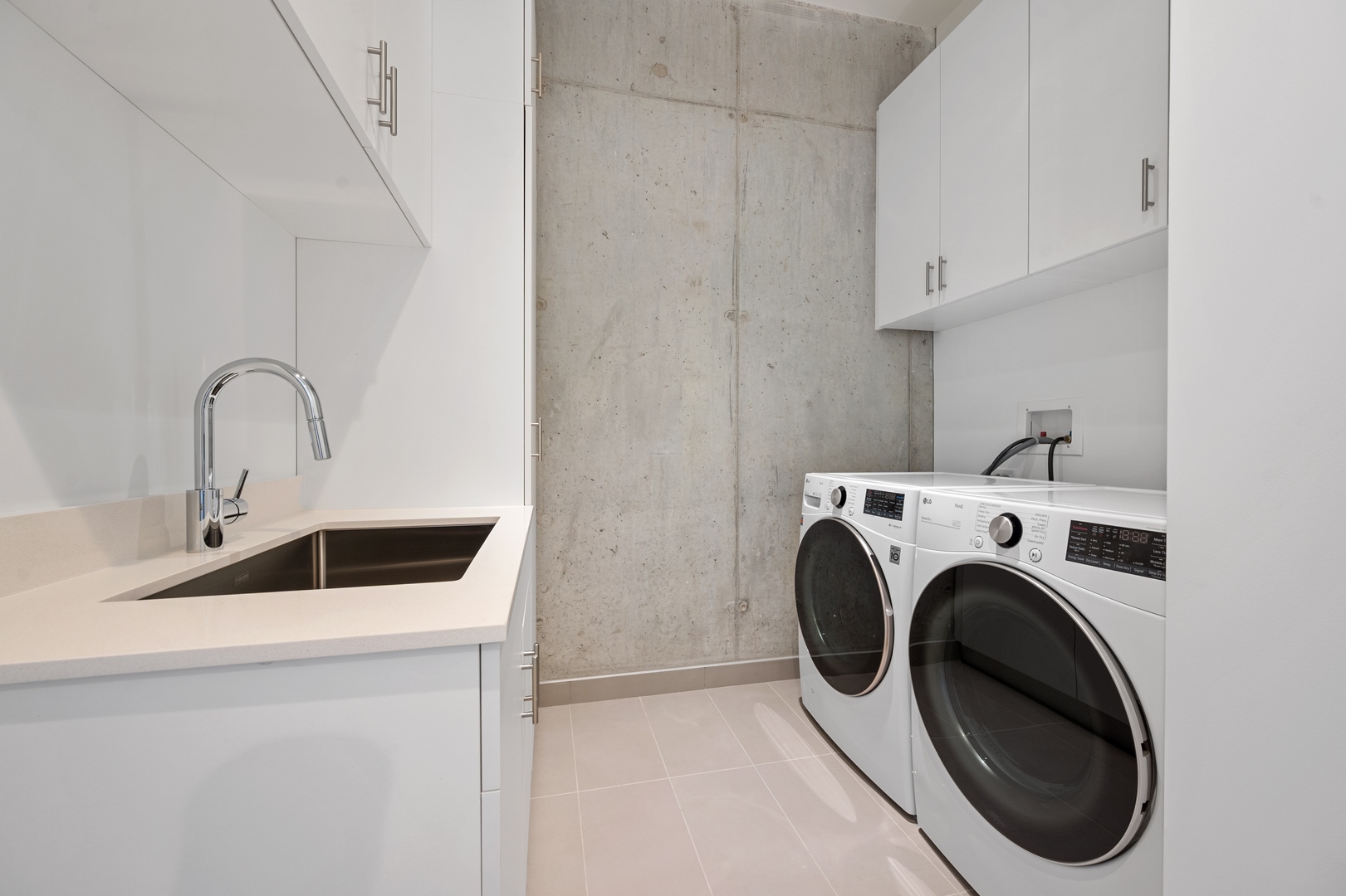 60 East Randolph Street, Unit 20D Chicago, IL 60601 - Photo 14 of 24 a utility room with sink dryer and washer