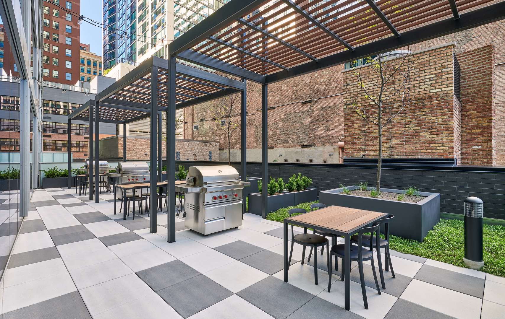 60 East Randolph Street, Unit 20D Chicago, IL 60601 - Photo 22 of 24 a view of a patio with table and chairs and potted plants