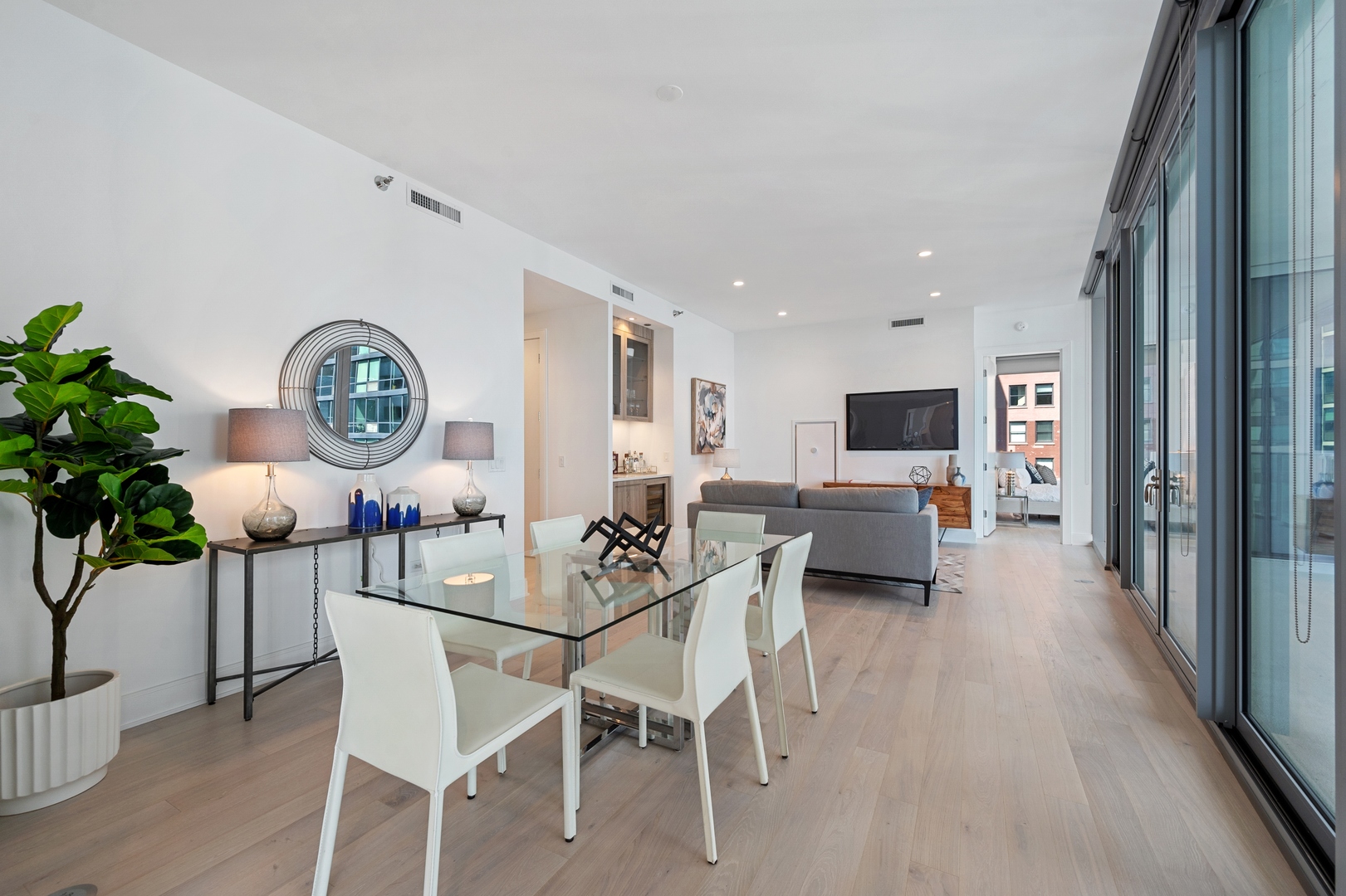 60 East Randolph Street, Unit 20D Chicago, IL 60601 - Photo 4 of 24 a view of a dining room with furniture and a clock