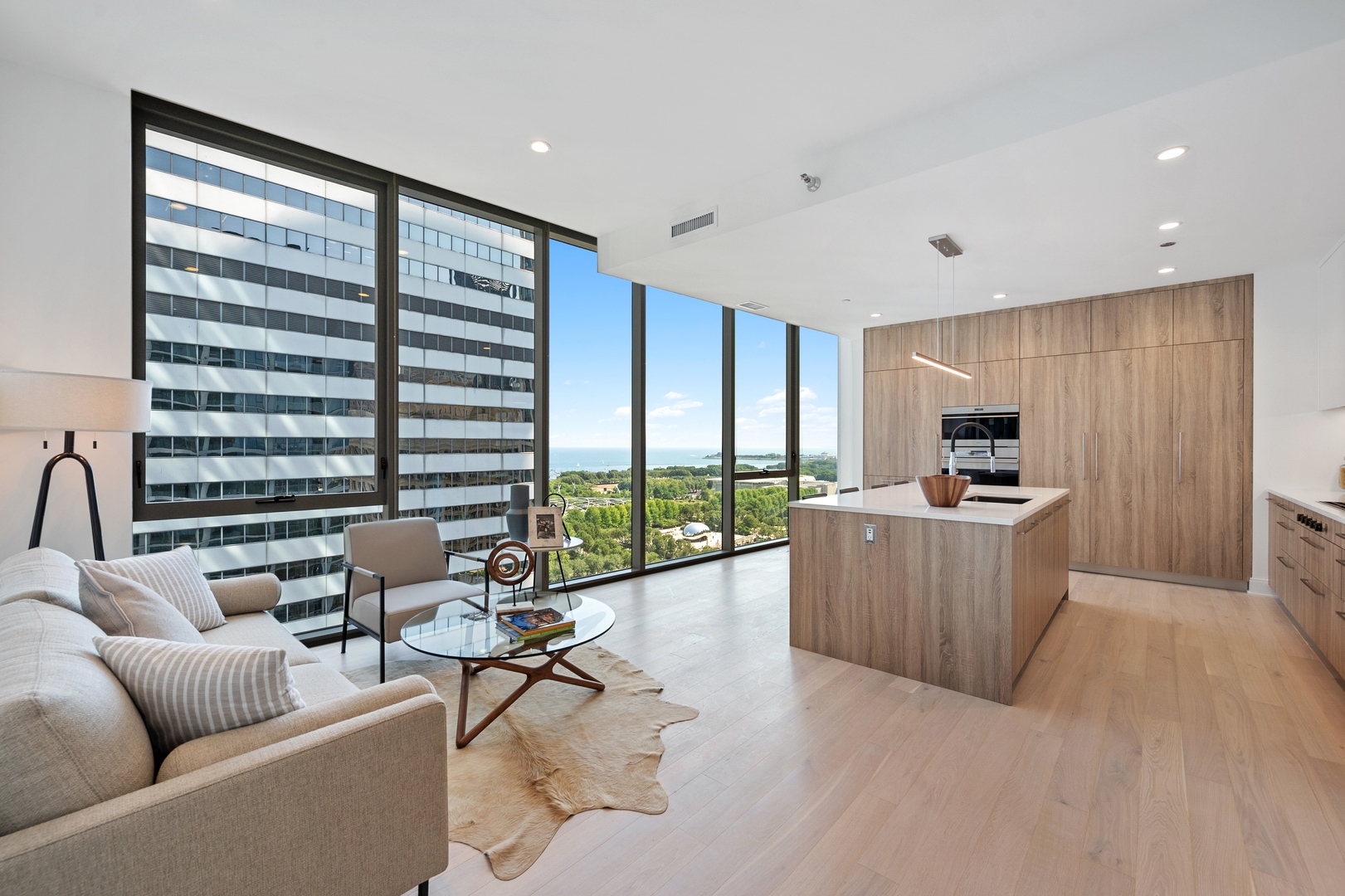 60 East Randolph Street, Unit 20D Chicago, IL 60601 - Photo 5 of 24 a living room with furniture and large windows