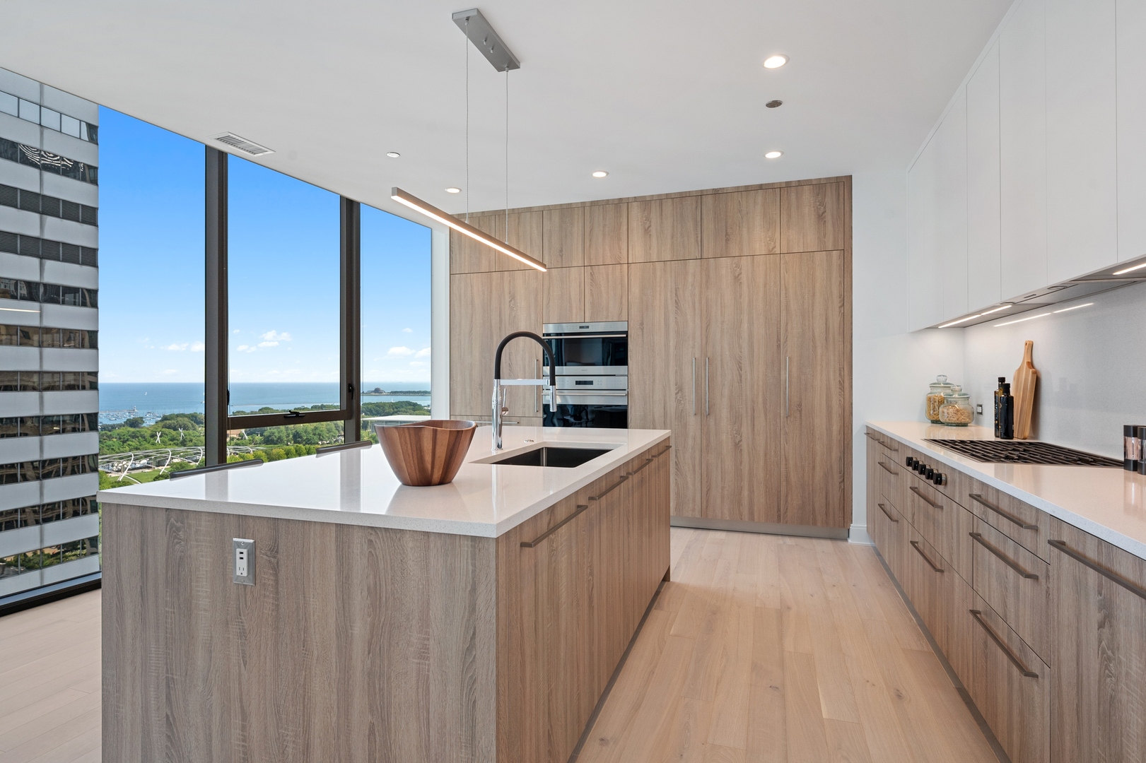 60 East Randolph Street, Unit 20D Chicago, IL 60601 - Photo 7 of 24 a kitchen with stainless steel appliances granite countertop a sink and a stove