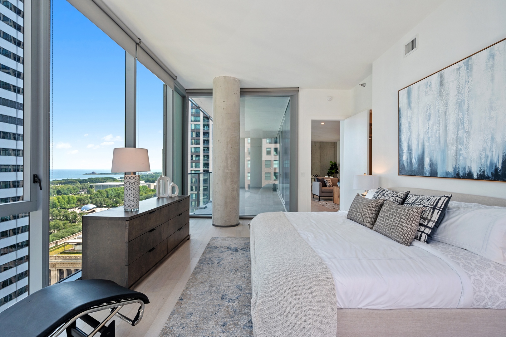 60 East Randolph Street, Unit 20D Chicago, IL 60601 - Photo 9 of 24 a bedroom with a bed and large windows