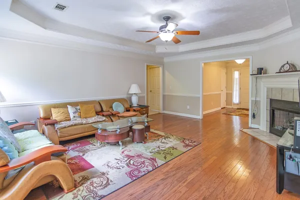 a kitchen with stainless steel appliances granite countertop a stove a sink dishwasher and cabinets with wooden floor