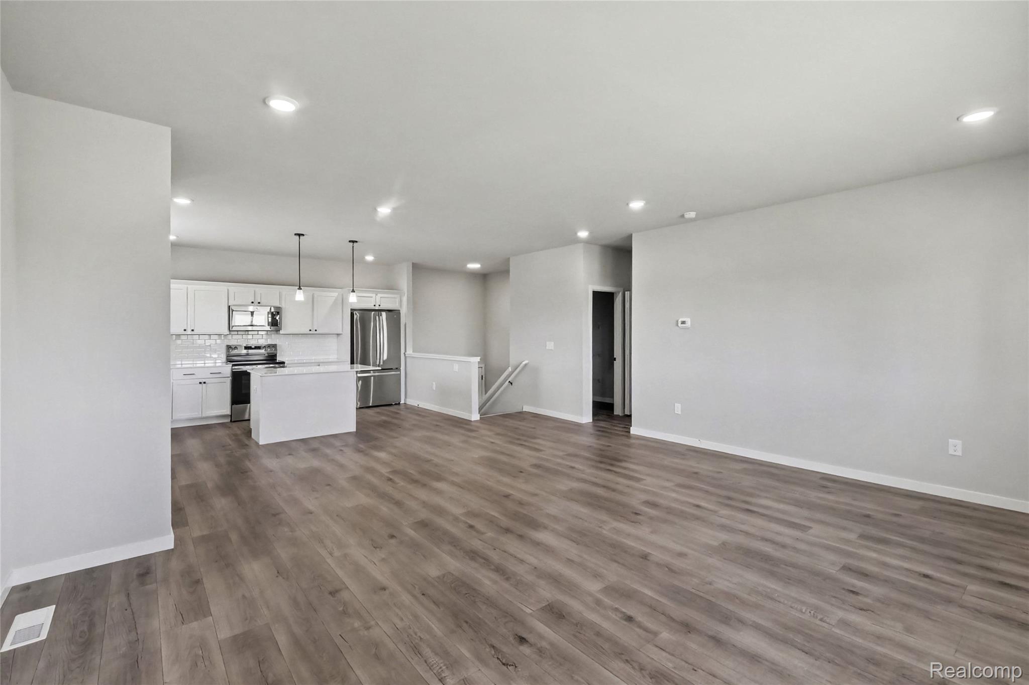 5528 Lahring Road Linden, MI 48451 - Photo 37 of 39 The open concept floorplan allows cohesive flow between the kitchen and dining room to a spacious great room.