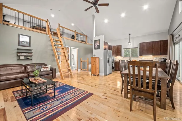 a living room with furniture a flat screen tv and a table