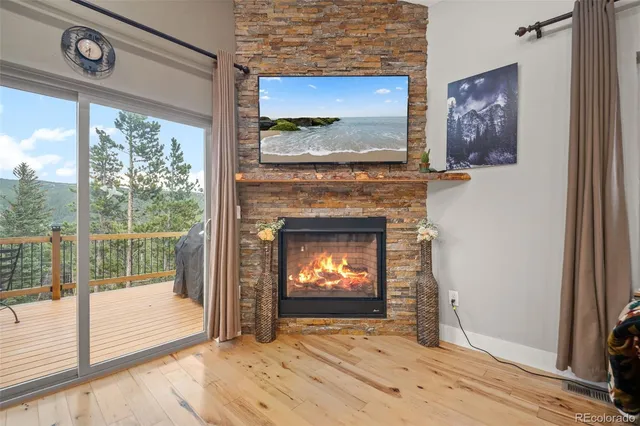 a view of an empty room with a fireplace and a window