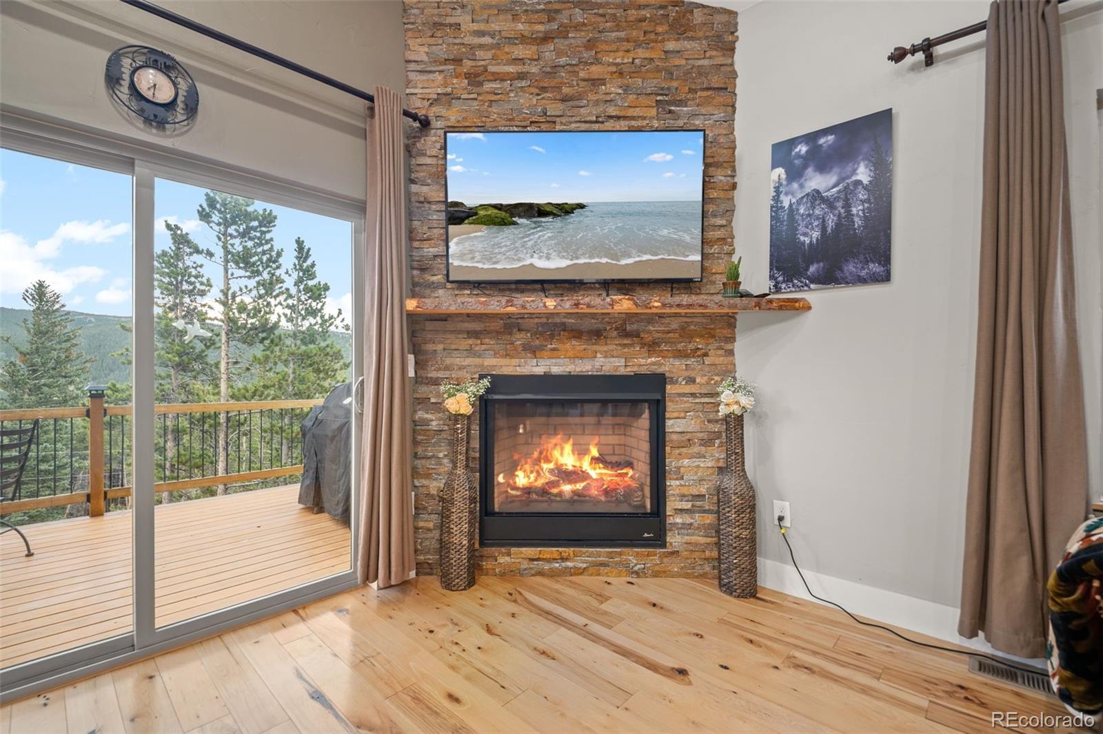 258 Upper Forest Road Idaho Springs, CO 80452 - Photo 12 of 48 a view of an empty room with a fireplace and a window