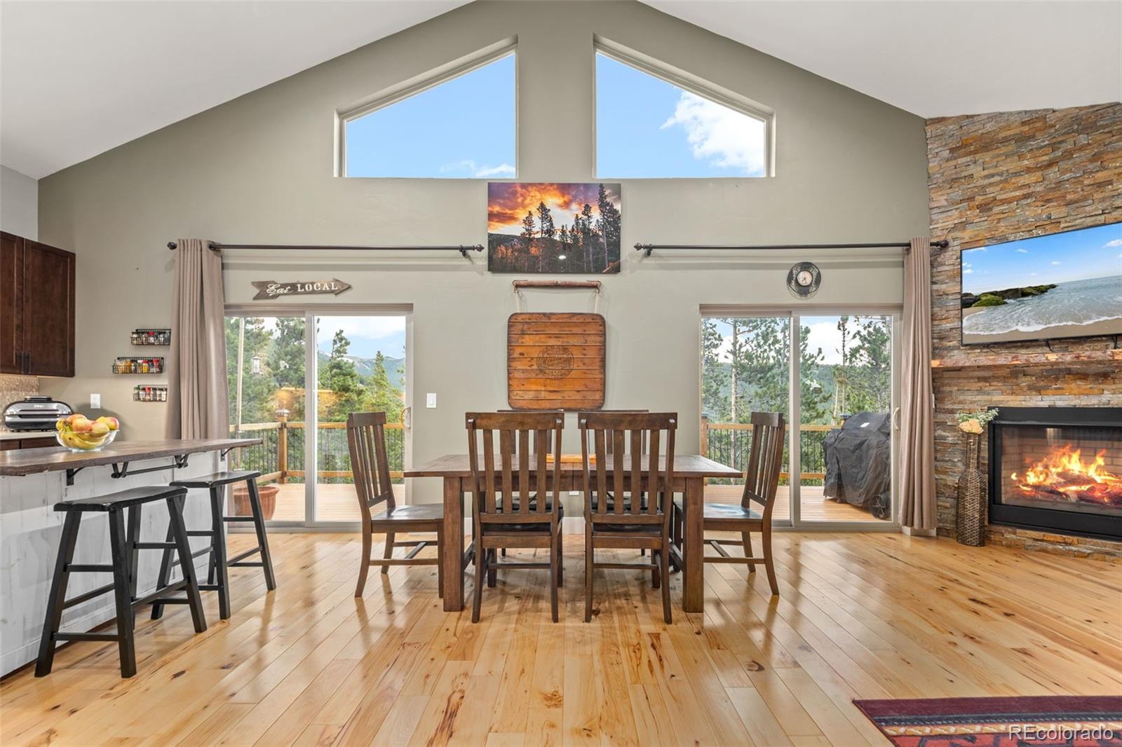 258 Upper Forest Road Idaho Springs, CO 80452 - Photo 13 of 48 a view of a dining room with furniture window and wooden floor