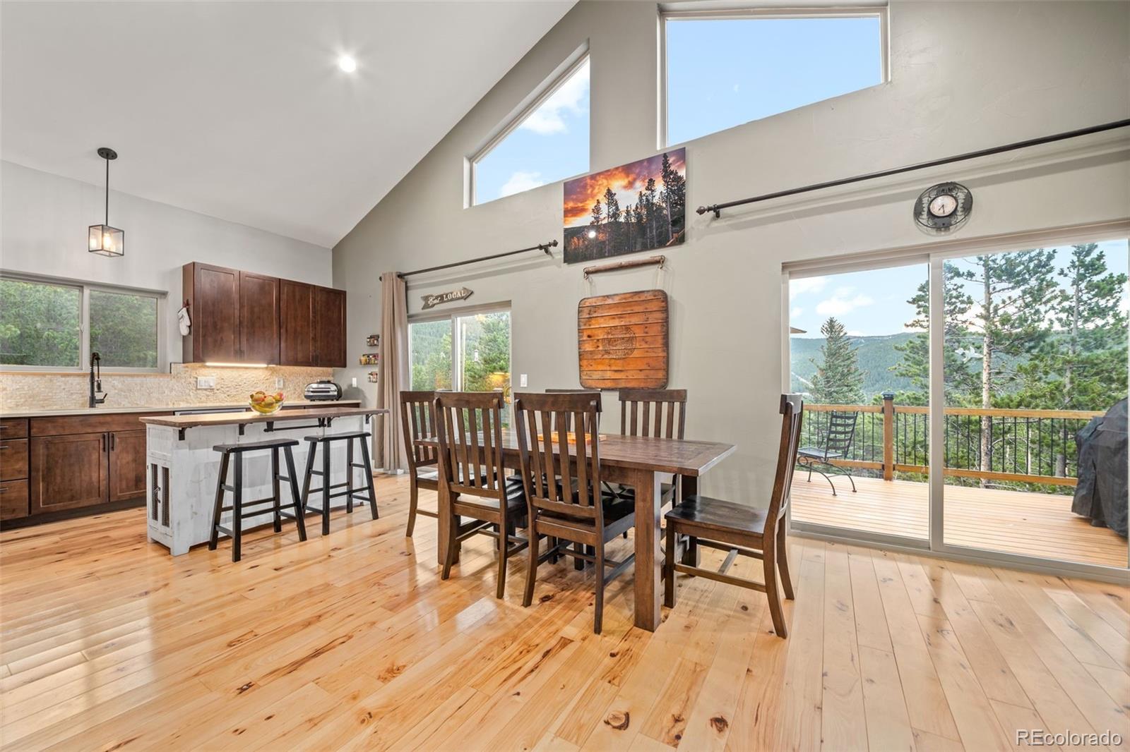 258 Upper Forest Road Idaho Springs, CO 80452 - Photo 14 of 48 a view of a dining room with furniture window and wooden floor