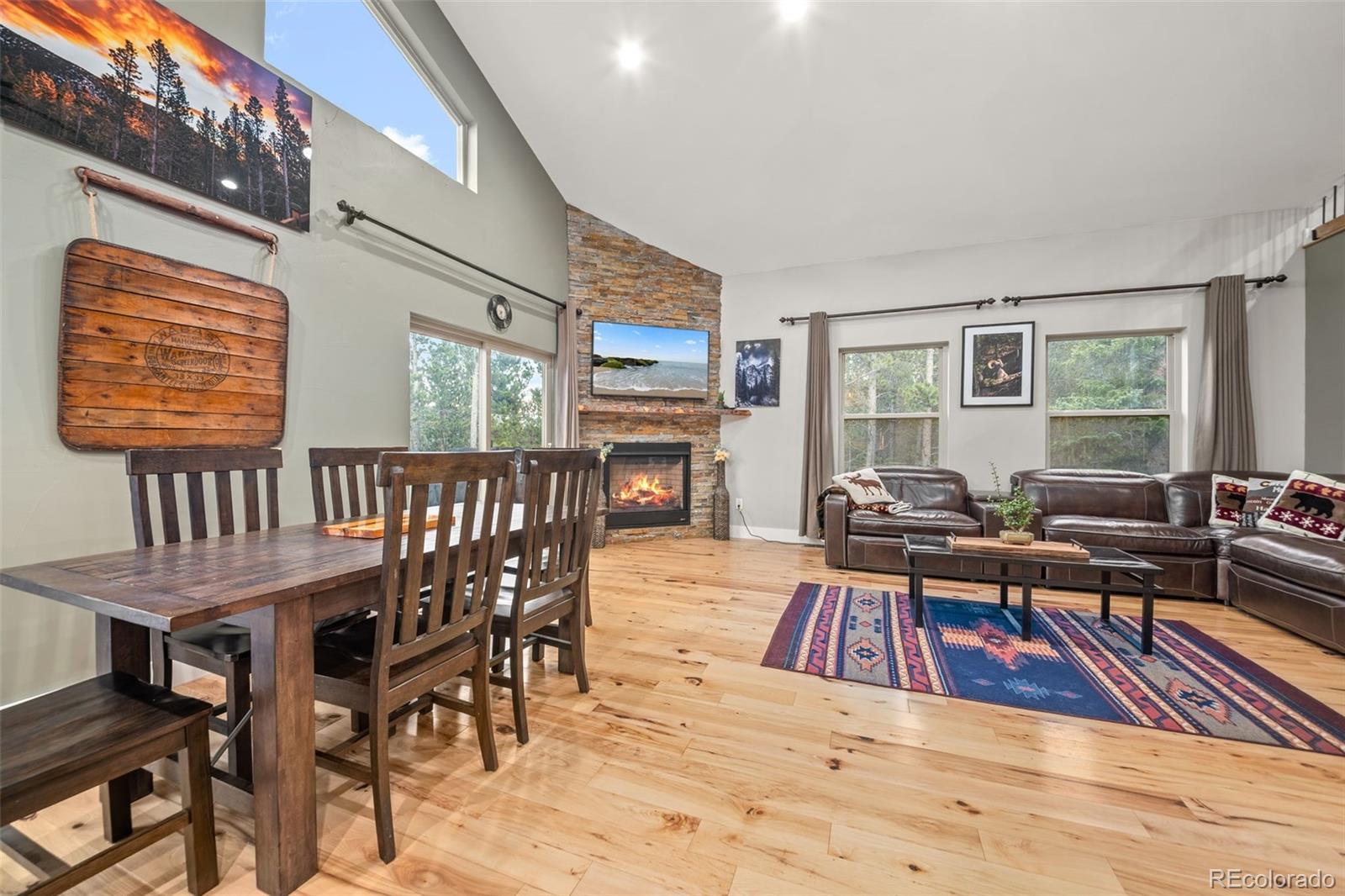 258 Upper Forest Road Idaho Springs, CO 80452 - Photo 15 of 48 a living room with furniture a rug wooden floor and a window