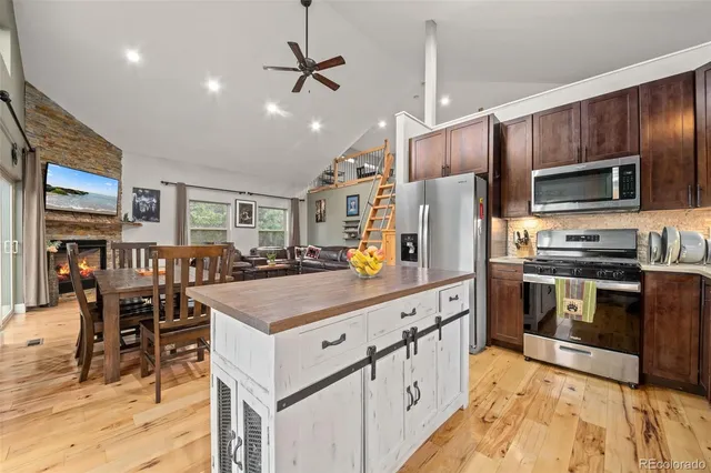 a kitchen with stainless steel appliances a stove refrigerator sink and microwave