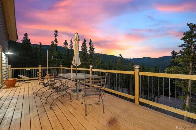 a view of roof deck with wooden floor and fence