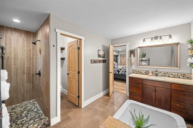 a bathroom with a double vanity sink mirror and bathtub