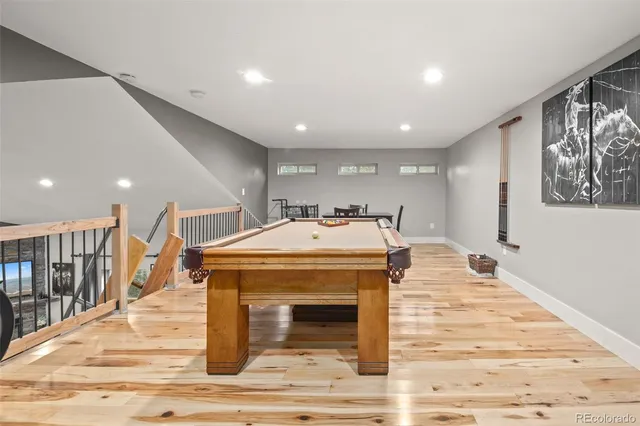 a hall with a stove a fireplace and wooden floor