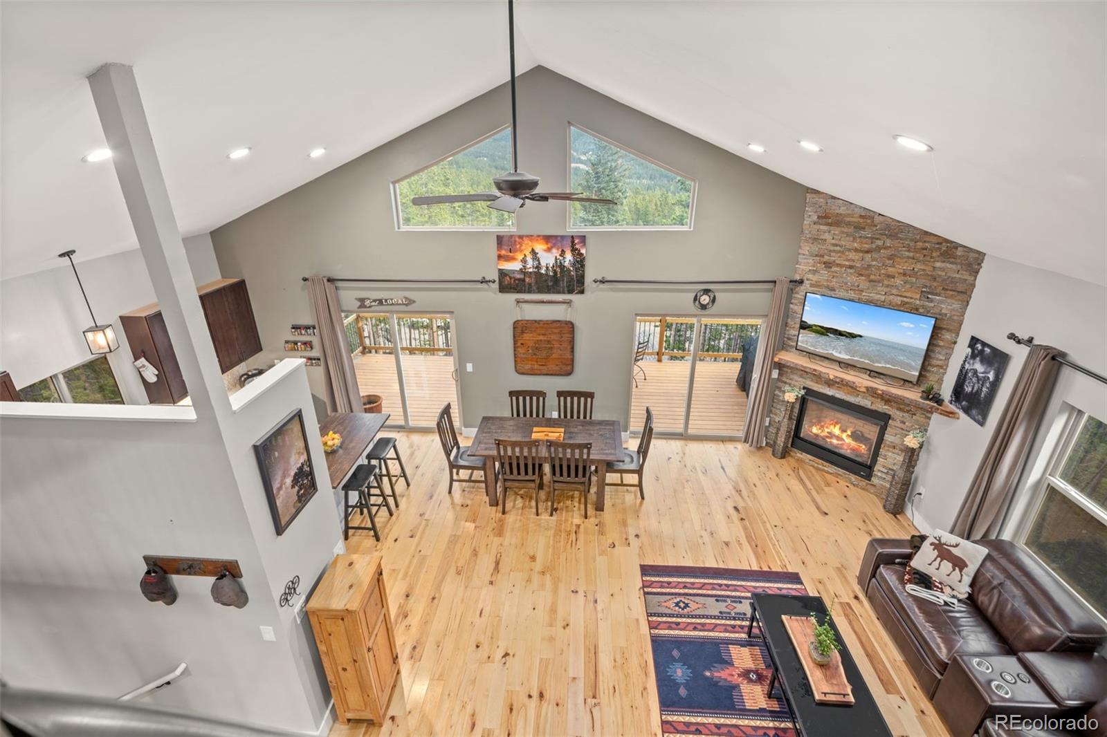 258 Upper Forest Road Idaho Springs, CO 80452 - Photo 25 of 48 a living room with furniture dining table and a chandelier