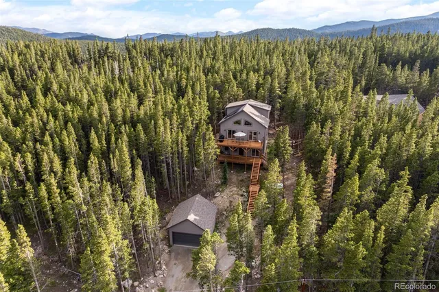 an aerial view of a house with a yard