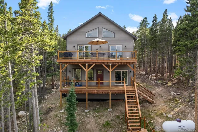 a front view of a house with balcony and garden