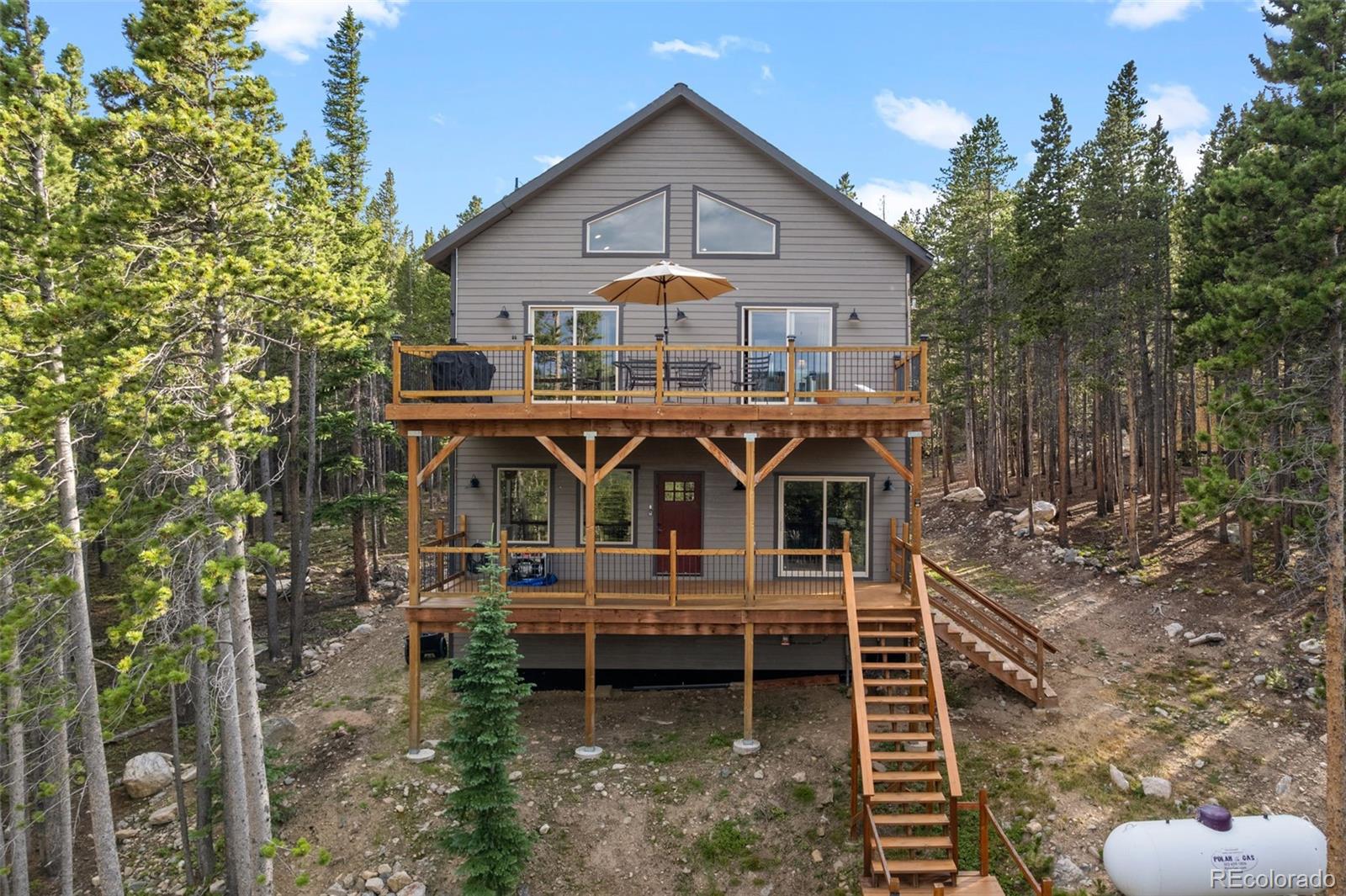 258 Upper Forest Road Idaho Springs, CO 80452 - Photo 32 of 48 a front view of a house with balcony and garden