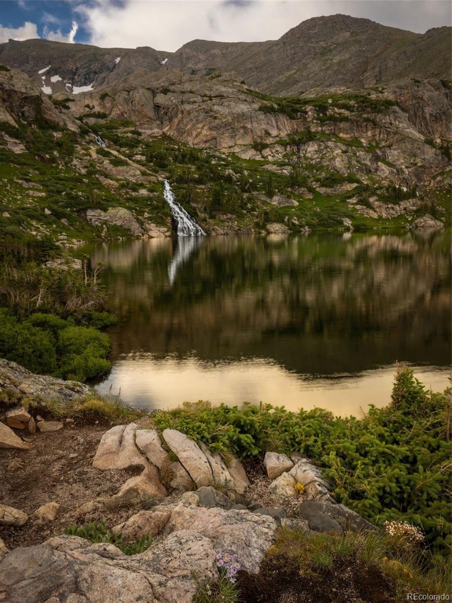 258 Upper Forest Road Idaho Springs, CO 80452 - Photo 42 of 48 a view of a lake with mountains in the background