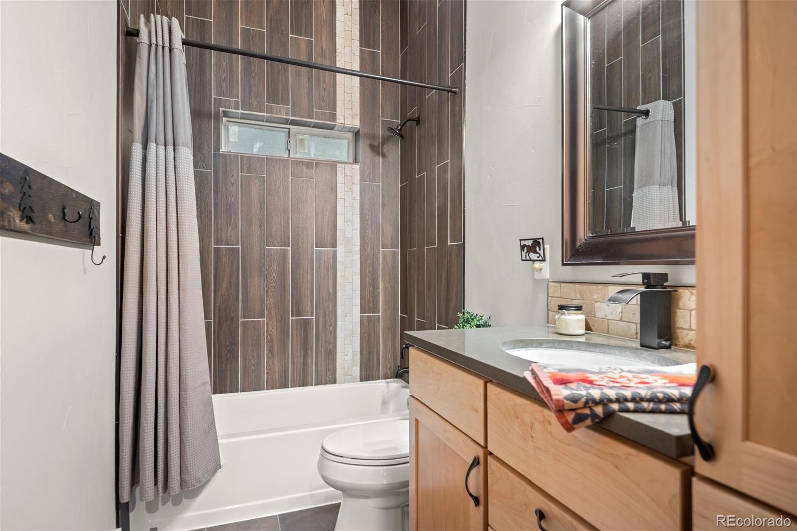 258 Upper Forest Road Idaho Springs, CO 80452 - Photo 9 of 48 a bathroom with a sink toilet and shower
