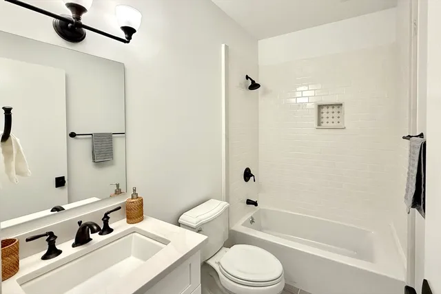 a bathroom with a sink mirror toilet and bathtub
