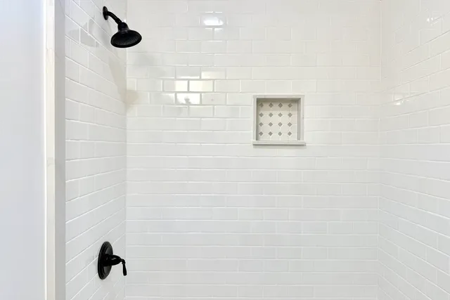 a large kitchen with kitchen island a stove a sink a center island and windows