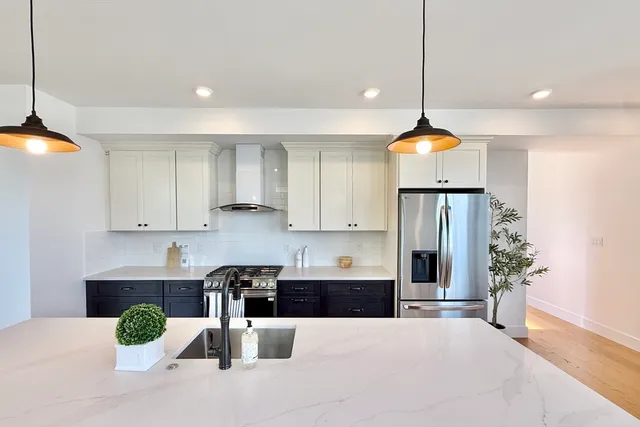 a kitchen with granite countertop a sink and cabinets