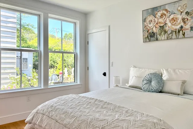 a bedroom with a large bed and a window