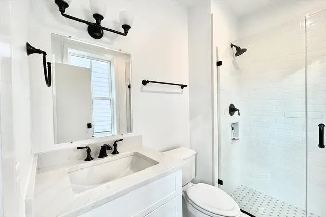 a bathroom with a sink toilet tub and shower