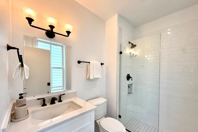 a bathroom with a sink toilet tub and shower
