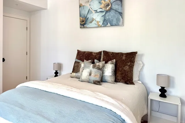 a bedroom with a bed and a painting