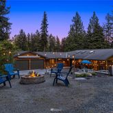 a view of a patio with furniture and a backyard