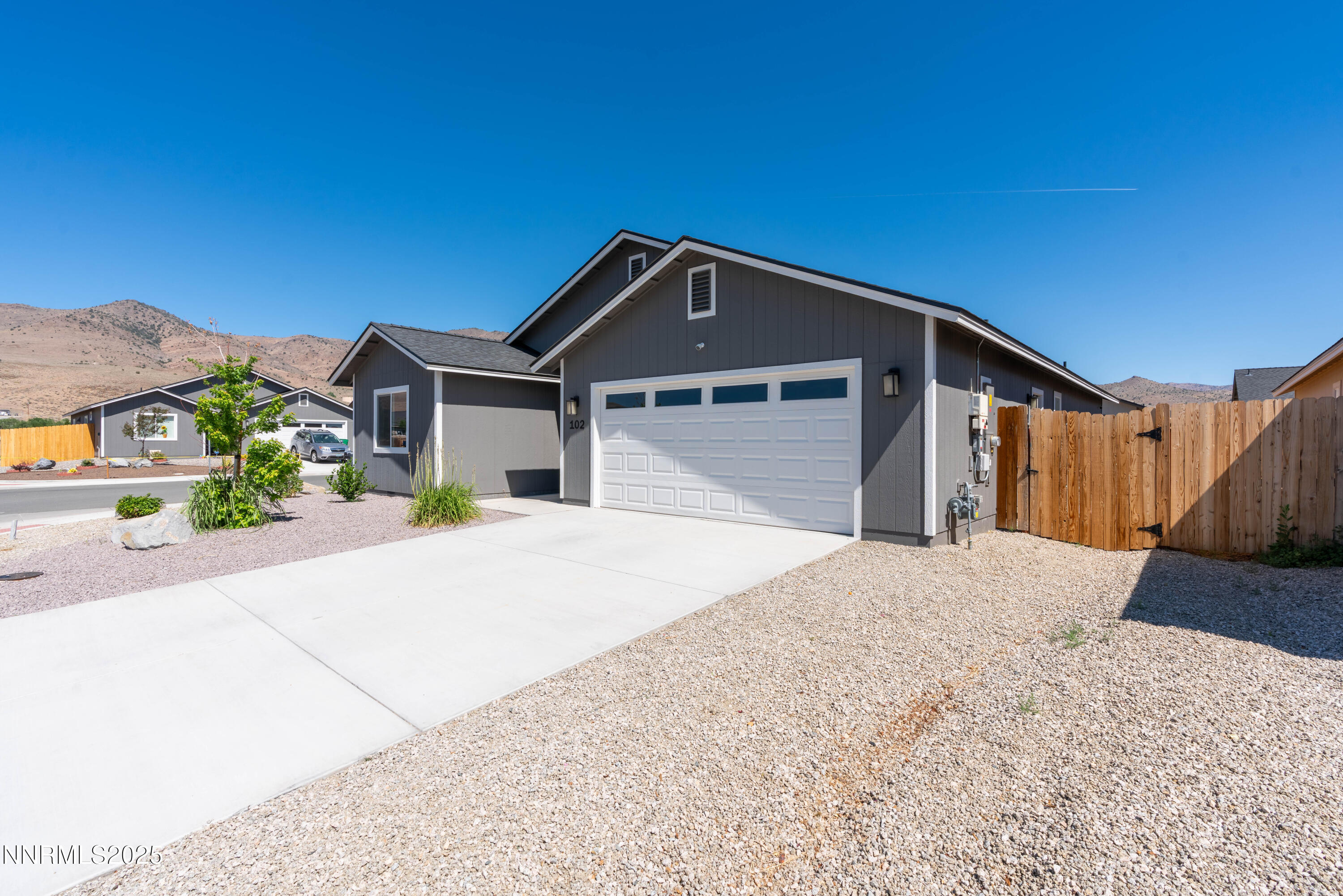 102 Halite Drive Dayton, NV 89403 - Photo 3 of 34 a front view of a house with a yard and garage