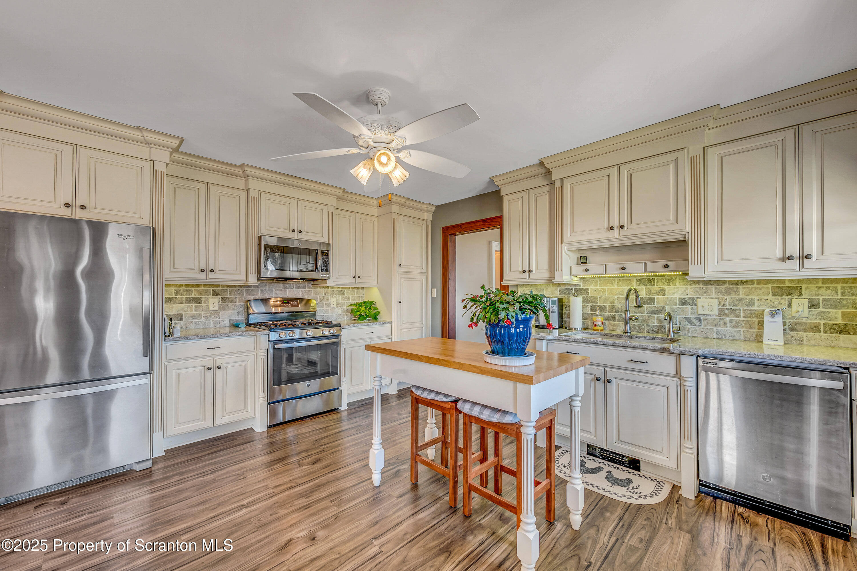 5115 State Rte 3013 Springville, PA 18844 - Photo 33 of 74 a kitchen with white cabinets and stainless steel appliances