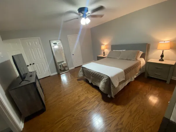 a bedroom with a bed and a chandelier