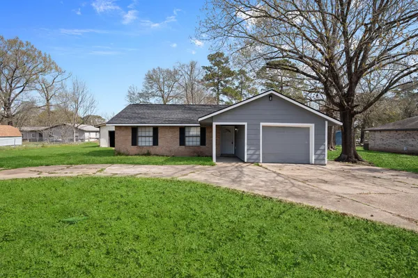 a front view of a house with a garden and yard
